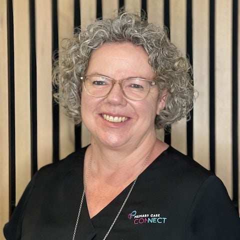 A woman with white skin and curly blonde hair